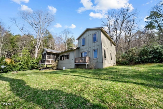 342 Ripshin Lake Rd, Roan Mountain, TN 37687 - rear view of house with board and batten siding, a lawn, and a sunroom