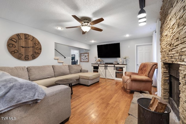1008 Cox Trail Pl, Kingsport, TN 37660 - living area with a ceiling fan, a fireplace, light wood-style floors, a textured ceiling, and recessed lighting