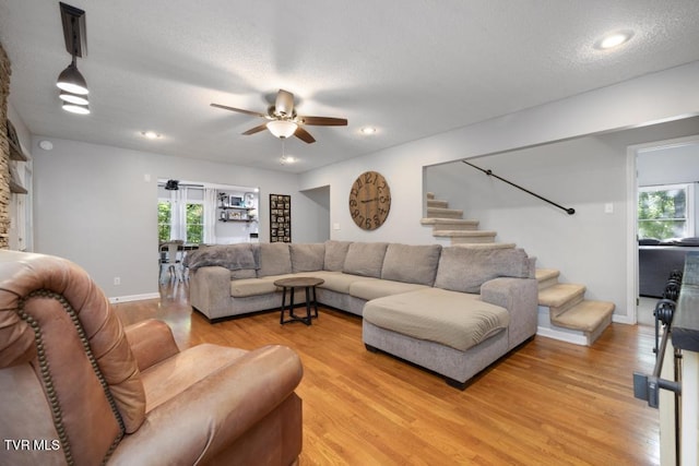1008 Cox Trail Pl, Kingsport, TN 37660 - living room with stairway, a ceiling fan, light wood finished floors, and a textured ceiling