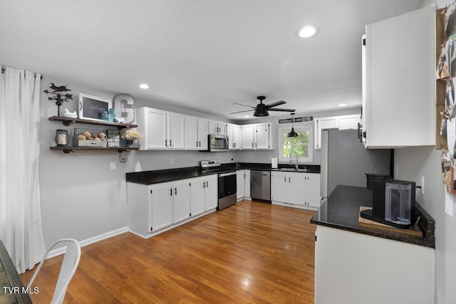 1008 Cox Trail Pl, Kingsport, TN 37660 - kitchen featuring appliances with stainless steel finishes, dark countertops, recessed lighting, ceiling fan, and white cabinets