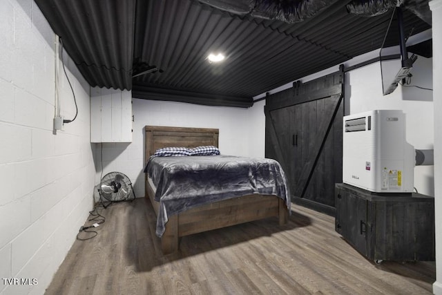 1008 Cox Trail Pl, Kingsport, TN 37660 - bedroom with a barn door, wood finished floors, and concrete block wall