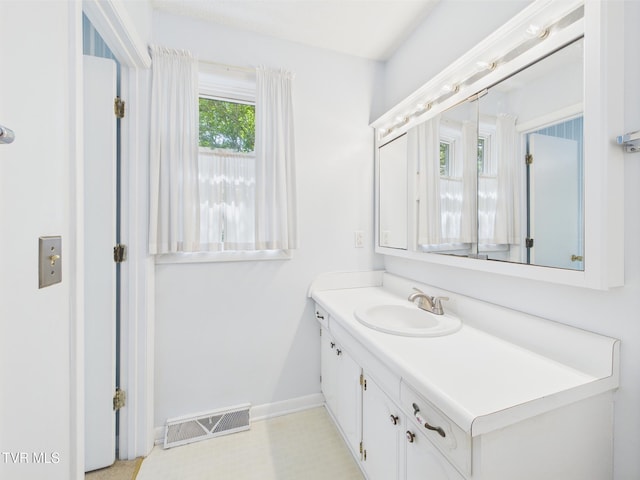 bathroom featuring baseboards, vanity, and visible vents