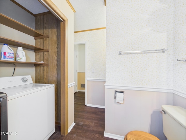 laundry room featuring laundry area, dark wood-style flooring, washer / clothes dryer, wainscoting, and wallpapered walls