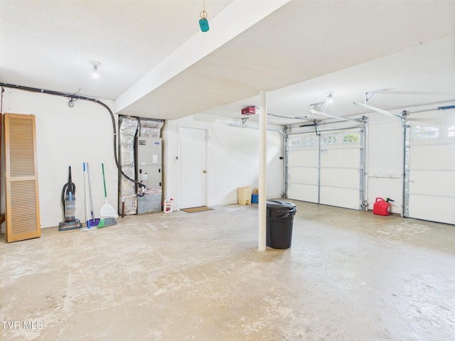 garage featuring heating unit and a garage door opener