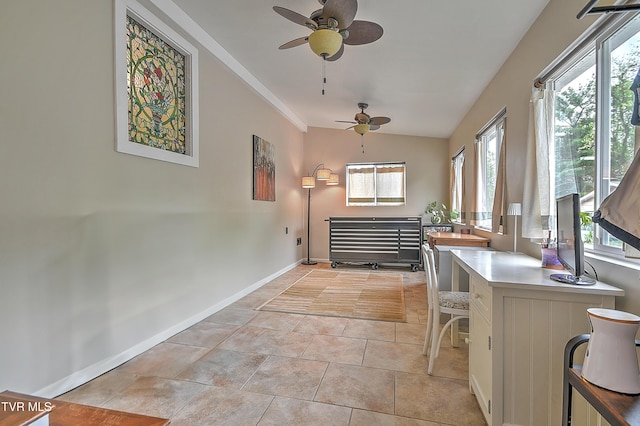 interior space featuring baseboards, ceiling fan, and a wealth of natural light