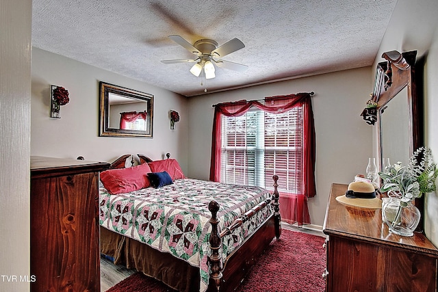 bedroom with a ceiling fan, a textured ceiling, and wood finished floors