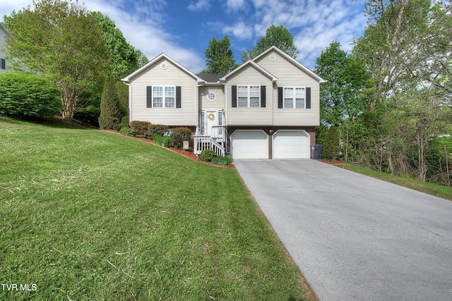 split foyer home with concrete driveway, an attached garage, and a front lawn