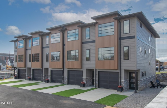 577 English St Unit B3, Bristol, TN 37620 - view of front of property featuring a garage, stone siding, and driveway