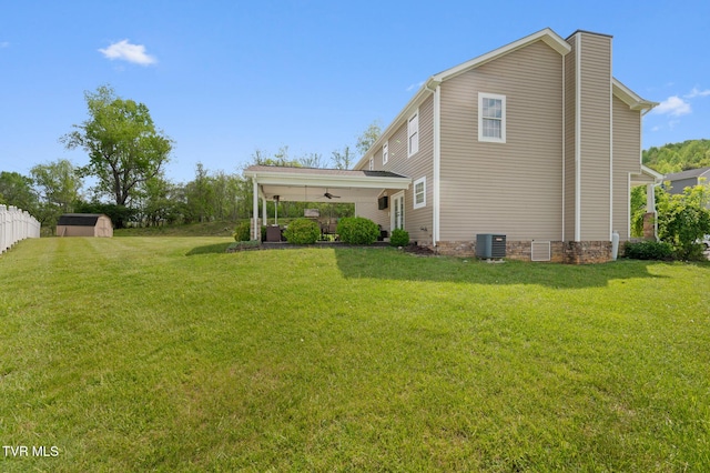 105 Dewey Ct, Bristol, VA 24201 - view of home's exterior featuring a ceiling fan, a chimney, a storage shed, a lawn, and central AC