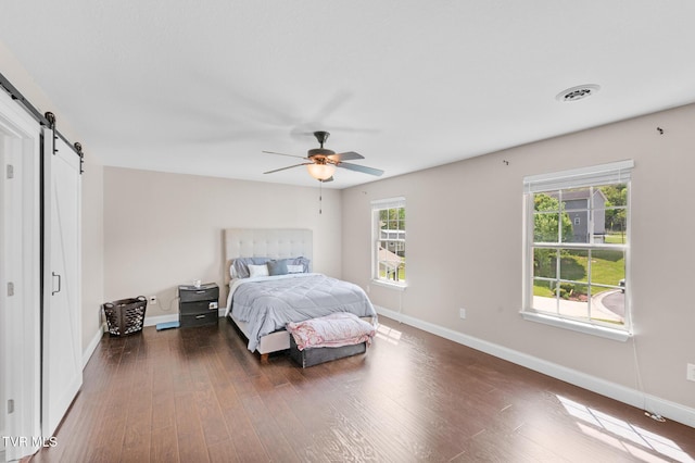 105 Dewey Ct, Bristol, VA 24201 - bedroom with ceiling fan, a barn door, baseboards, wood finished floors, and visible vents