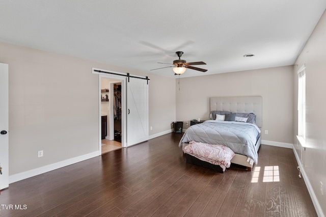 105 Dewey Ct, Bristol, VA 24201 - bedroom with baseboards, a ceiling fan, a barn door, and wood finished floors