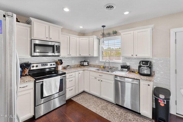 105 Dewey Ct, Bristol, VA 24201 - kitchen featuring visible vents, appliances with stainless steel finishes, tasteful backsplash, a sink, and white cabinets