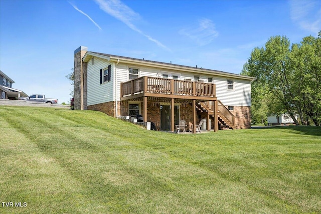rear view of property with a yard, a deck, a chimney, and stairway