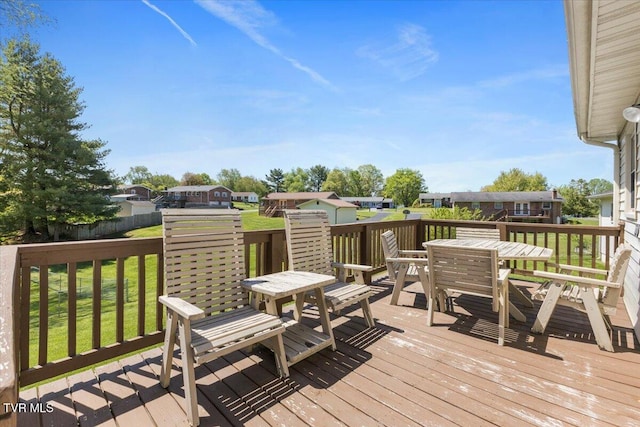 wooden deck featuring a yard and outdoor dining space