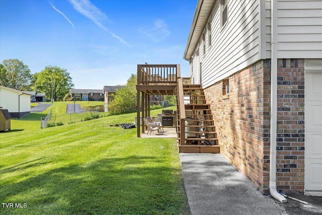 view of yard featuring stairway, a wooden deck, and a patio area