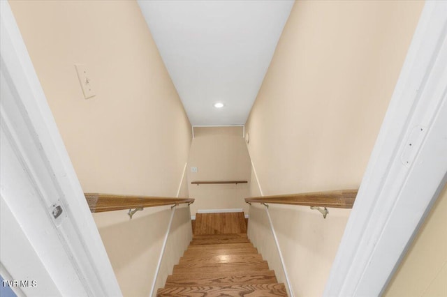stairway with recessed lighting and wood finished floors