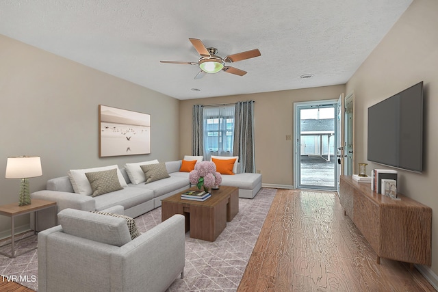 1544 Jessee St Unit S, Kingsport, TN 37664 - living room featuring baseboards, ceiling fan, light wood-type flooring, and a textured ceiling