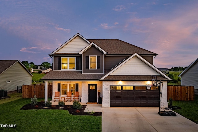 view of front of property featuring fence, a front lawn, brick siding, a porch, and driveway