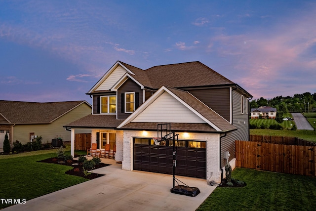 view of front of property featuring a garage, fence, a front yard, brick siding, and driveway