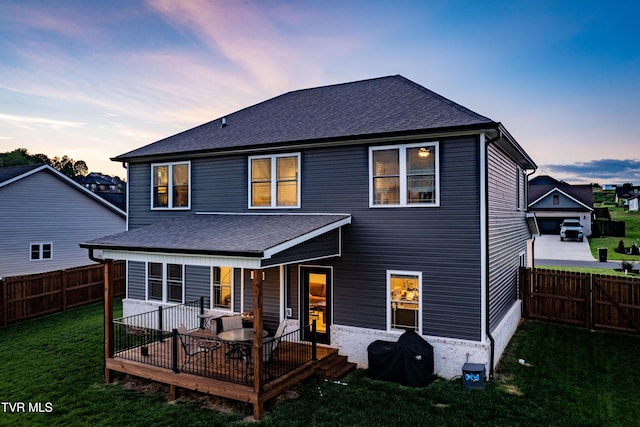 rear view of property with a yard, a fenced backyard, and roof with shingles