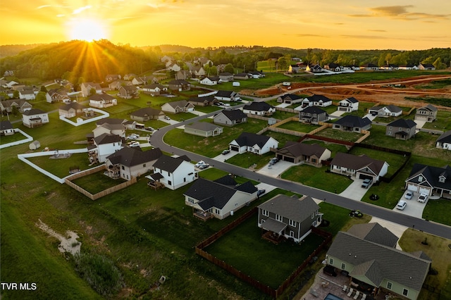 aerial view at dusk featuring a residential view