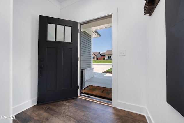 entryway featuring baseboards and wood finished floors