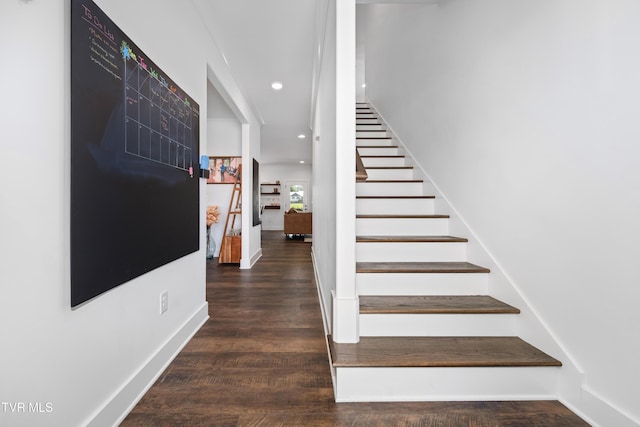 stairway featuring recessed lighting, baseboards, and wood finished floors