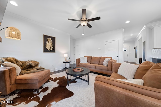 living area with baseboards, ornamental molding, a ceiling fan, and recessed lighting