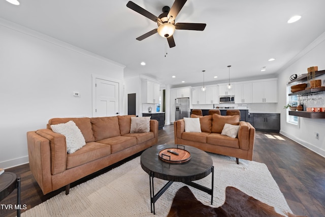 living room featuring crown molding, baseboards, a ceiling fan, and recessed lighting