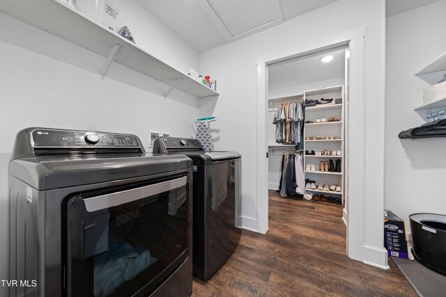 clothes washing area featuring laundry area, attic access, dark wood-style floors, and independent washer and dryer