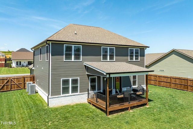 rear view of property featuring a fenced backyard, central AC, a yard, and a deck
