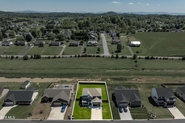 birds eye view of property with a mountain view and a residential view