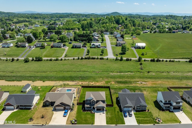 drone / aerial view featuring a residential view and a mountain view