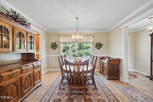 dining space with an inviting chandelier, ornamental molding, baseboards, and stone finish floor