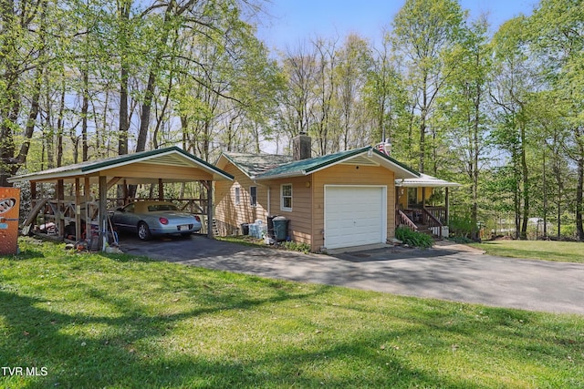 368 Burbank Rd, Roan Mountain, TN 37687 - exterior space with a detached garage, a chimney, a yard, and aphalt driveway