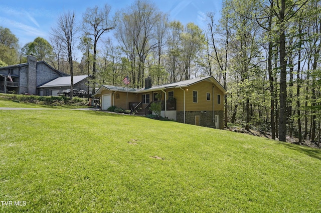 368 Burbank Rd, Roan Mountain, TN 37687 - view of front of property with a garage, a front lawn, and a chimney