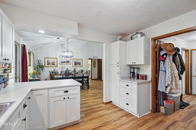 368 Burbank Rd, Roan Mountain, TN 37687 - kitchen with light wood-style floors, light countertops, white cabinets, and a peninsula