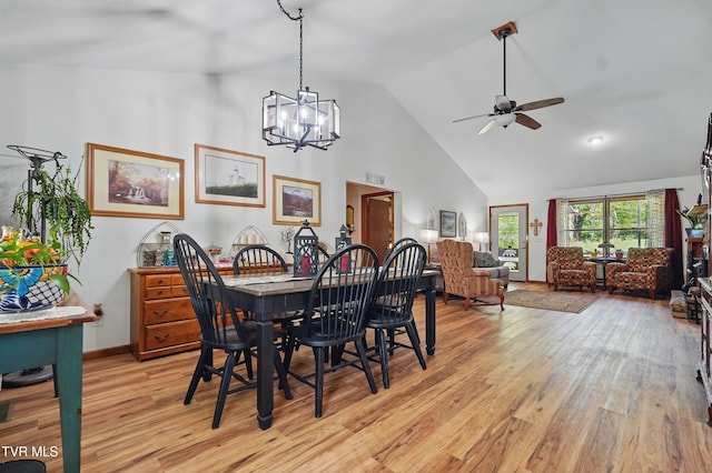 368 Burbank Rd, Roan Mountain, TN 37687 - dining room featuring light wood-type flooring, baseboards, ceiling fan with notable chandelier, and high vaulted ceiling