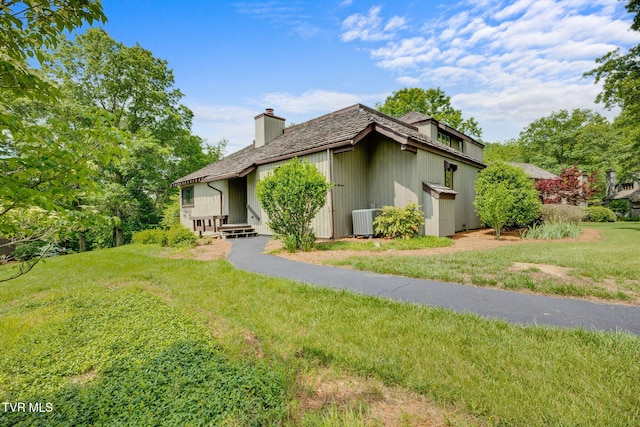 100 Periwinkle Pl Unit 100, Kingsport, TN 37660 - back of property featuring a chimney, central air condition unit, and a lawn