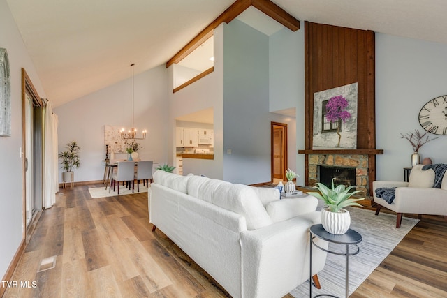 100 Periwinkle Pl Unit 100, Kingsport, TN 37660 - living area with a chandelier, high vaulted ceiling, light wood-style flooring, beam ceiling, and a stone fireplace