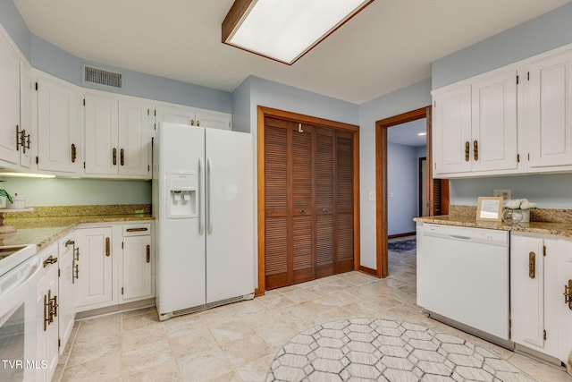 100 Periwinkle Pl Unit 100, Kingsport, TN 37660 - kitchen featuring white appliances, white cabinets, light stone counters, and baseboards