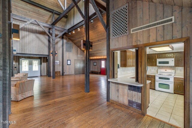 100 Periwinkle Pl Unit 100, Kingsport, TN 37660 - kitchen with white appliances, high vaulted ceiling, wooden walls, light countertops, and light wood-style flooring