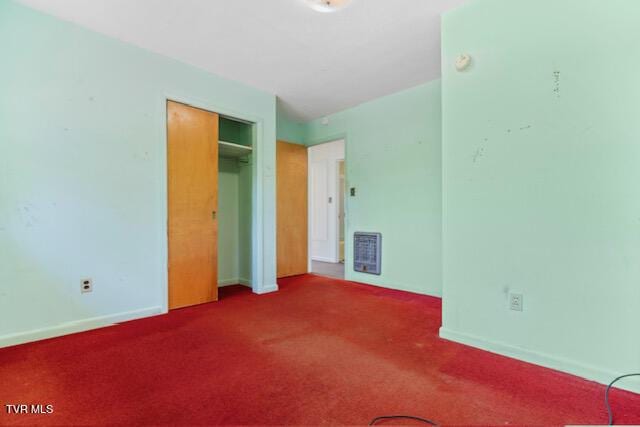 unfurnished bedroom with a closet, baseboards, carpet flooring, and visible vents