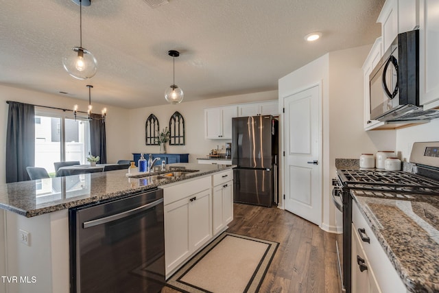 kitchen featuring a textured ceiling, appliances with stainless steel finishes, and a sink