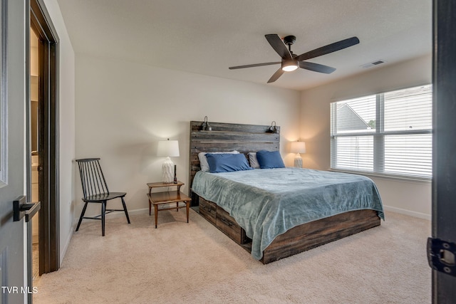 carpeted bedroom featuring a ceiling fan, baseboards, and visible vents