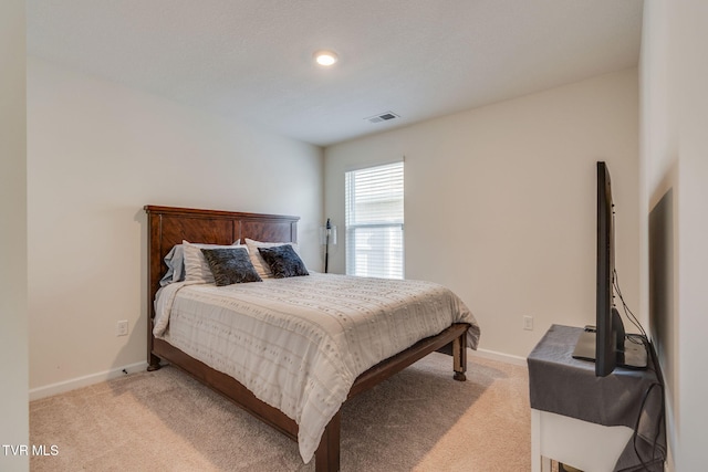 bedroom featuring light colored carpet, baseboards, and visible vents
