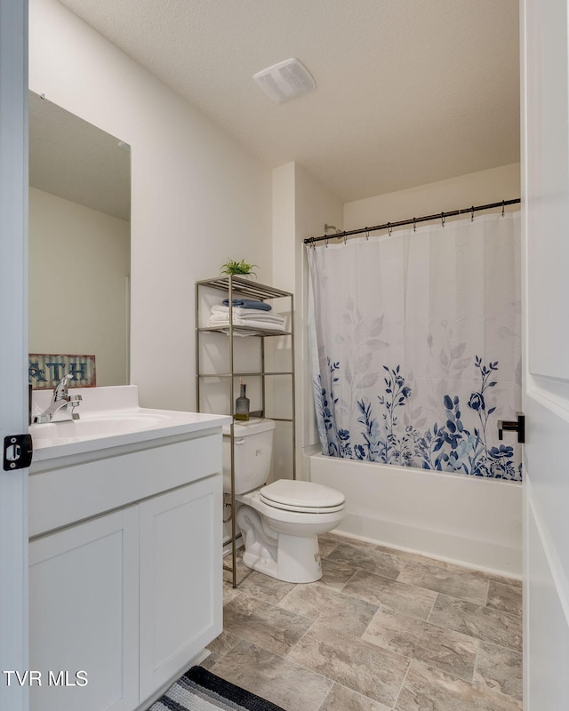 bathroom with visible vents, vanity, toilet, shower / bathtub combination with curtain, and stone finish floor