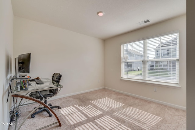 carpeted office featuring baseboards and visible vents