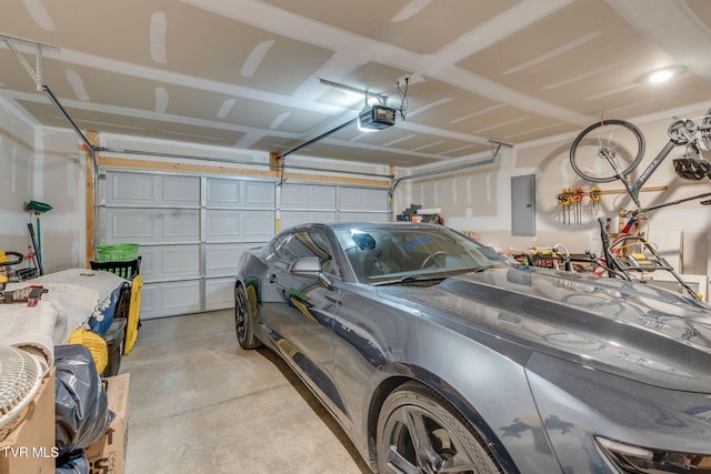 garage with a garage door opener and electric panel