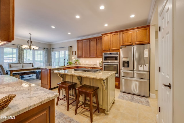 kitchen featuring light stone countertops, stainless steel appliances, recessed lighting, a peninsula, and ornamental molding